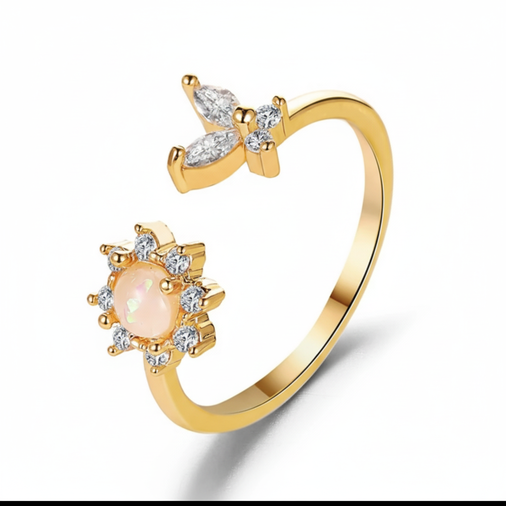 Gold ring with a pink gemstone and diamond accents on a white background