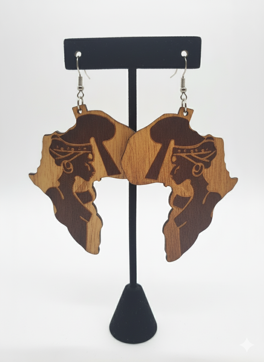Wooden earrings shaped like Africa with a silhouette of a woman on a black stand against a white background.