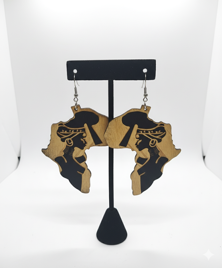 Earrings shaped like Africa with a person on a black stand against a white background