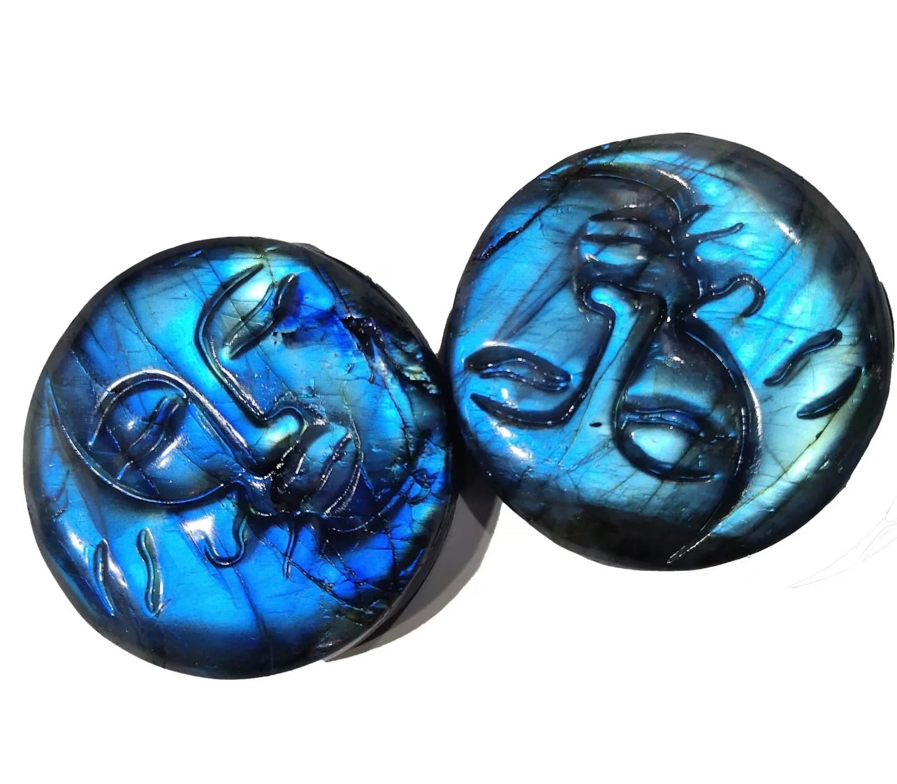 A pair of blue labradorite moon face charms with a metallic and glass construction.