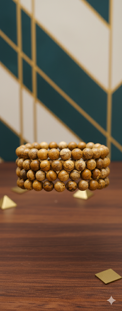 Stack of beaded bracelets on a wooden surface with a geometric patterned wall in the background